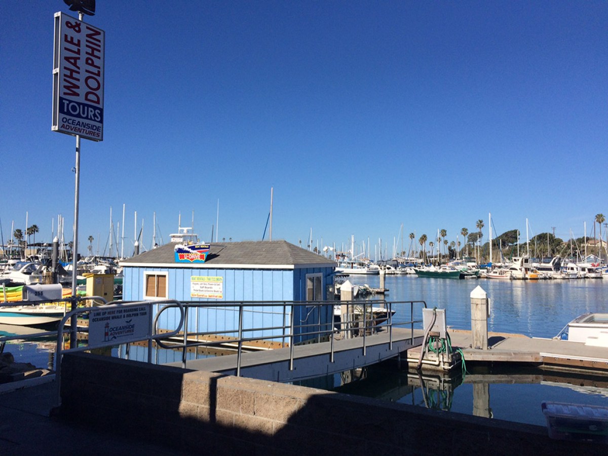 a boat is docked next to a body of water