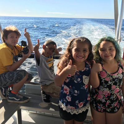 a group of people on a beach posing for the camera