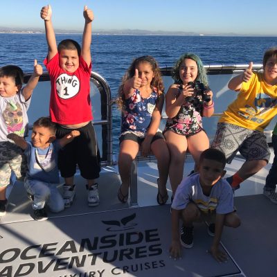 a group of people on a beach posing for the camera