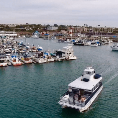 a harbor filled with lots of small boats in a large body of water