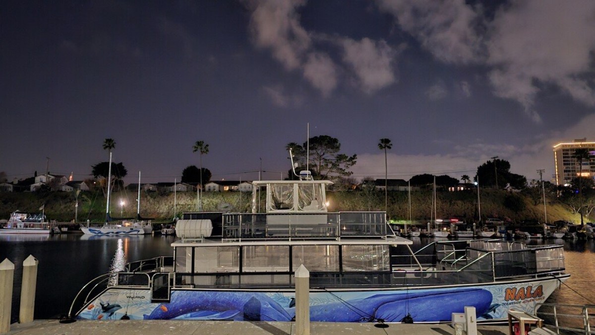 a boat is docked next to a body of water