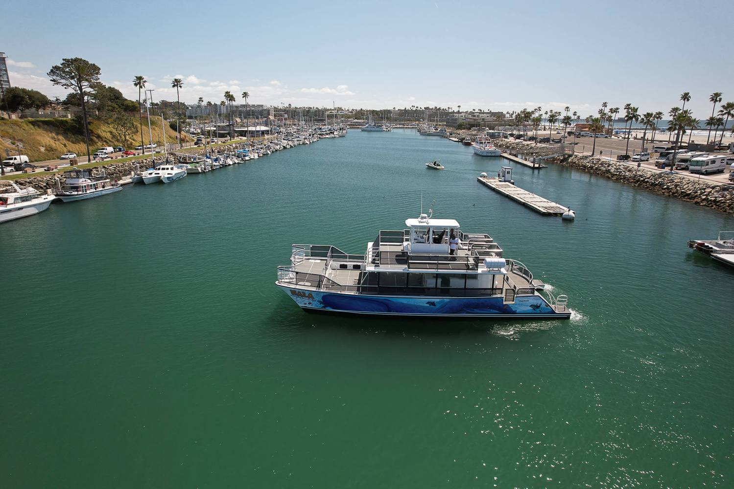 a small boat in a harbor next to a body of water