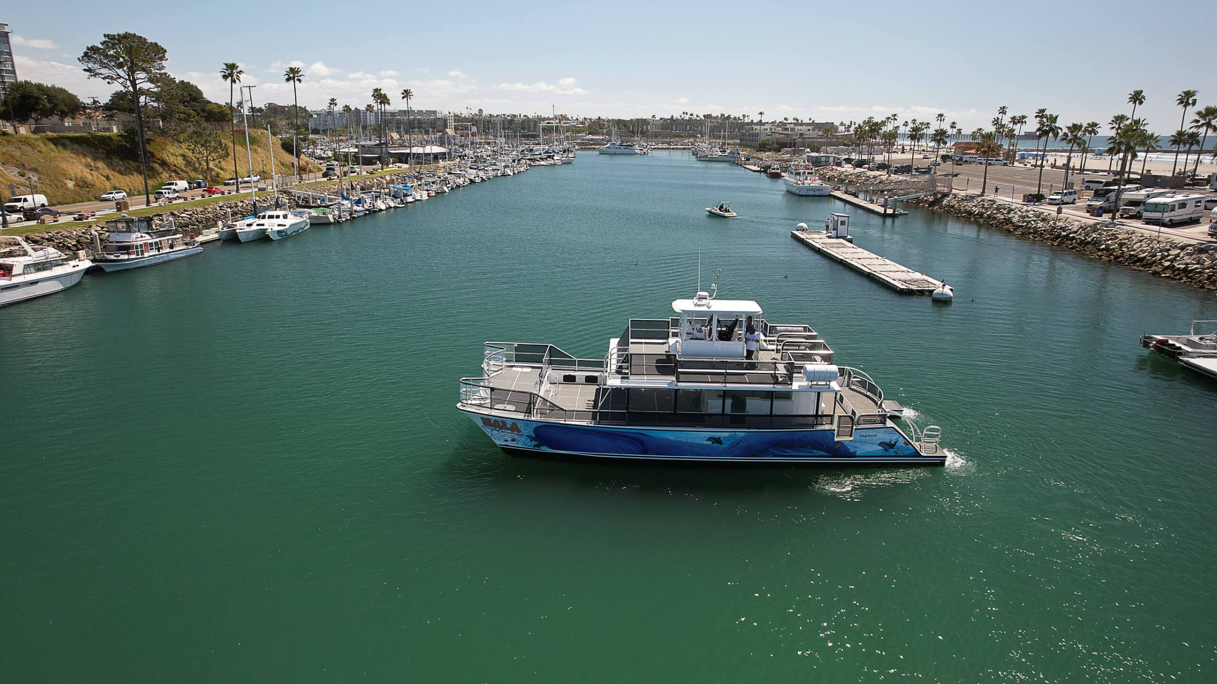 a small boat in a harbor next to a body of water