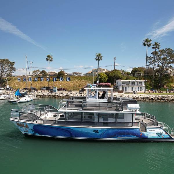 a boat is docked next to a body of water