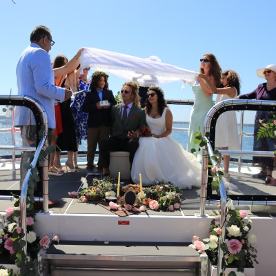 a group of people standing in front of a mirror posing for the camera