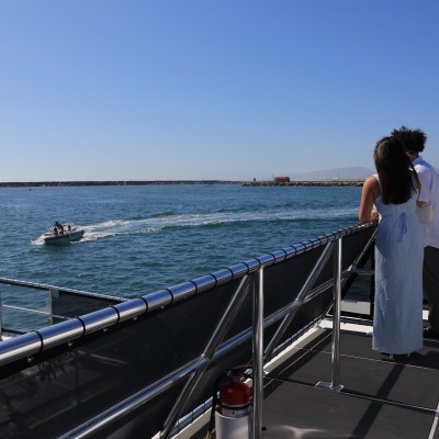 a person sitting on a dock next to a body of water